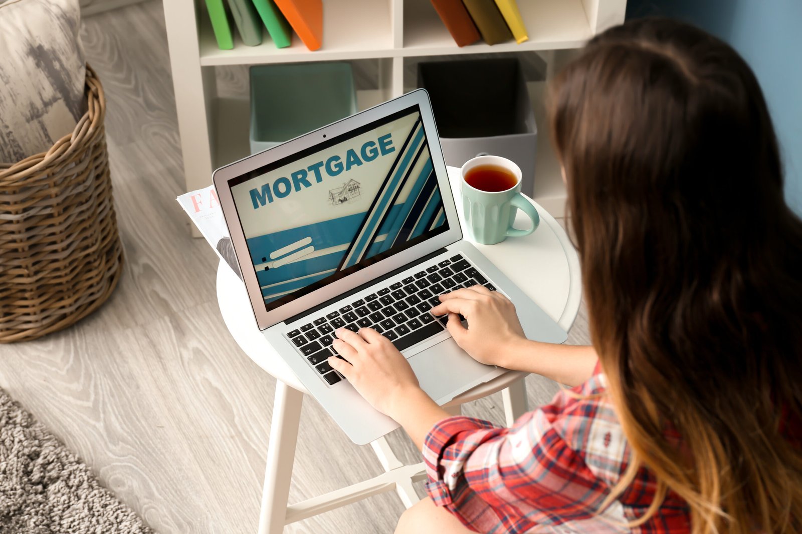 Woman using laptop to pay mortgage loan online at home